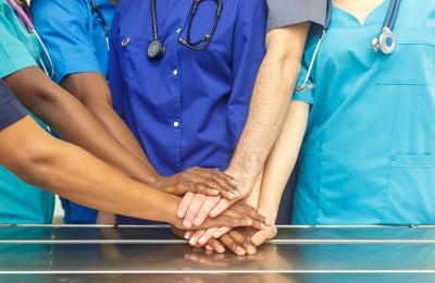 Multiethnic doctor hold hands