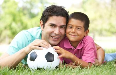 father and son with a soccer ball