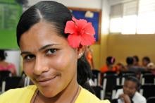 Woman with red flower behind ear