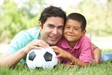 father and son with a soccer ball